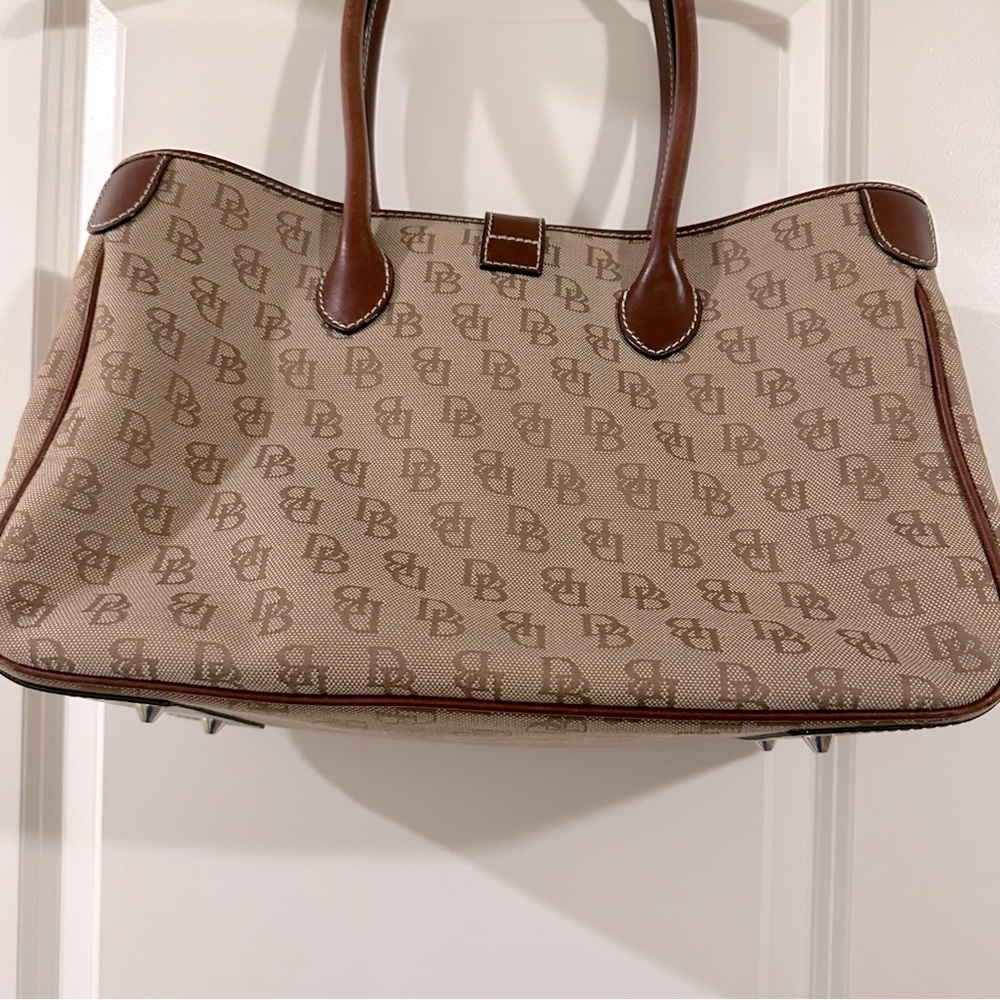 Dooney & Bourke authentic tote bag with clasp and design on outside EUC